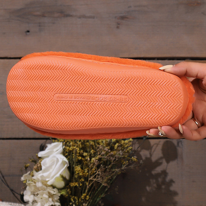 Textured orange sole of a pumpkin plush slipper